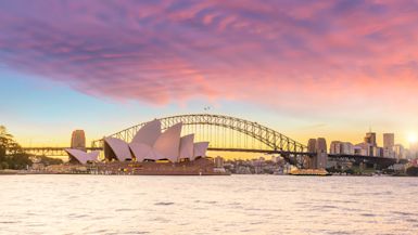A photograph of the Sydney Opera House along the water's edge